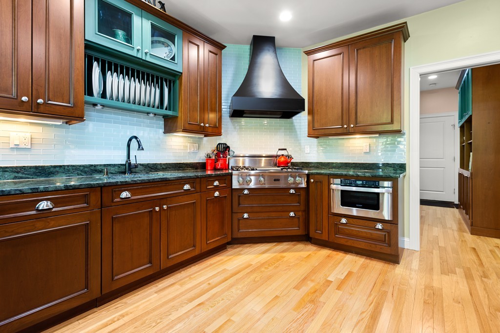 21 South Cottage Road, Unit 21 Belmont, MA 02478 - Photo 6 of 27 a kitchen with stainless steel appliances granite countertop a stove a sink and a microwave