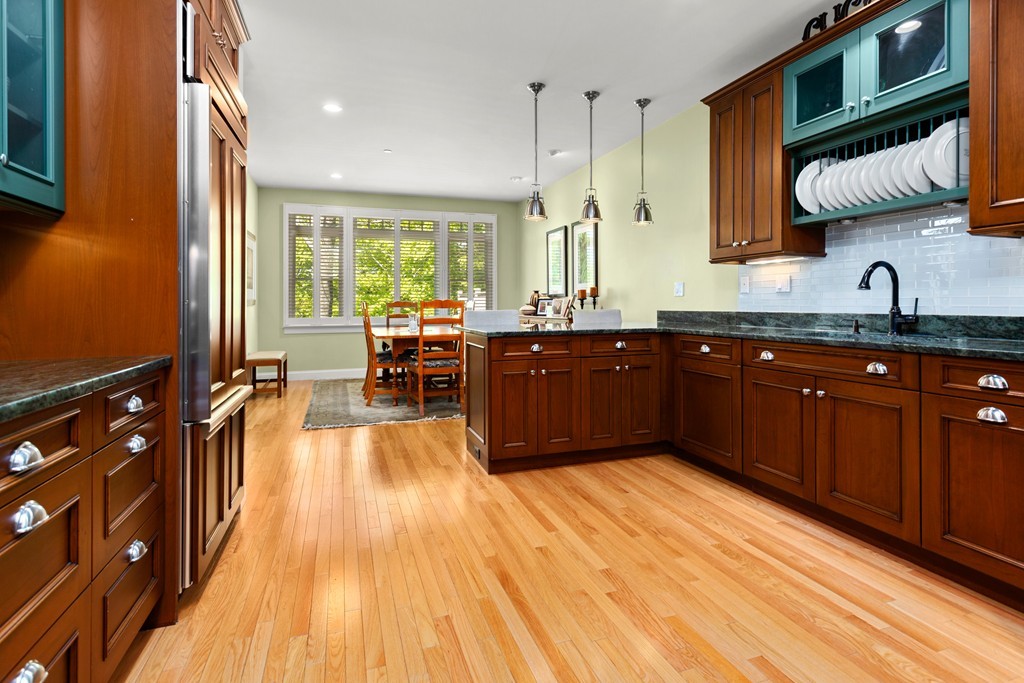 21 South Cottage Road, Unit 21 Belmont, MA 02478 - Photo 8 of 27 a large kitchen with wooden floors and stainless steel appliances