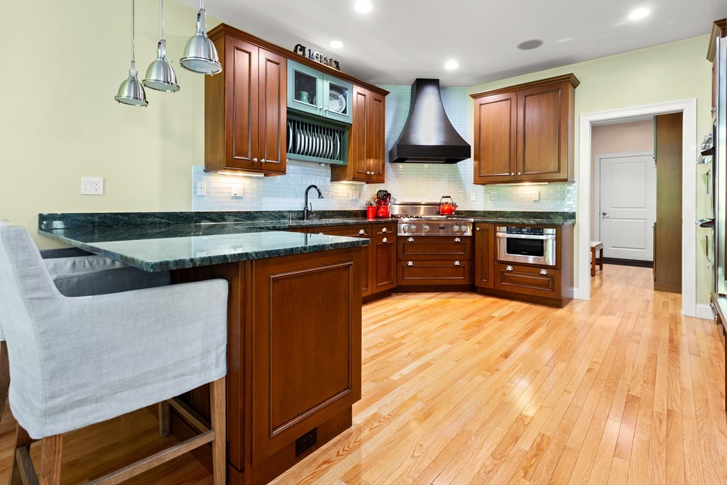 21 South Cottage Road, Unit 21 Belmont, MA 02478 - Photo 9 of 27 a kitchen with stainless steel appliances granite countertop wooden cabinets a stove top oven a sink and dishwasher