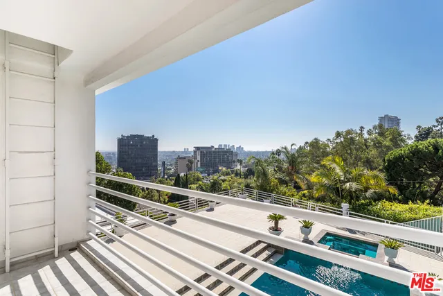 a bathroom with double vanity sinks and a shower