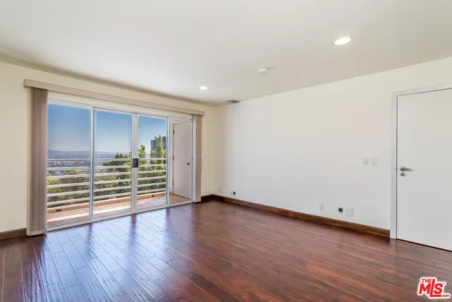 an empty room with wooden floor