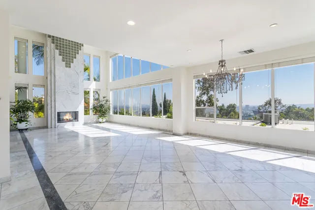 a view of a lobby with chair and a potted plant