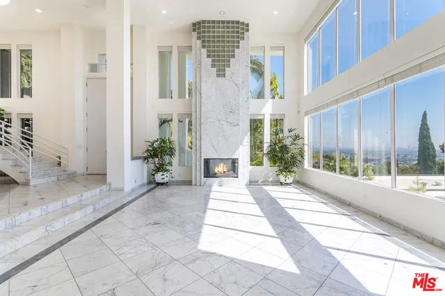 a front view of a house with a yard glass top table and chairs