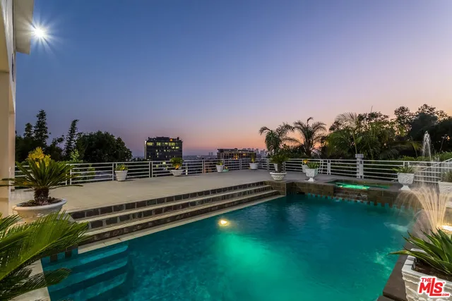 a view of a palm trees front of house