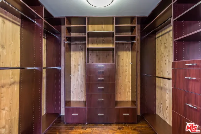 a large kitchen with stainless steel appliances a large counter top