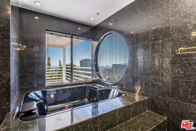 a view of empty room with wooden floor and fireplace