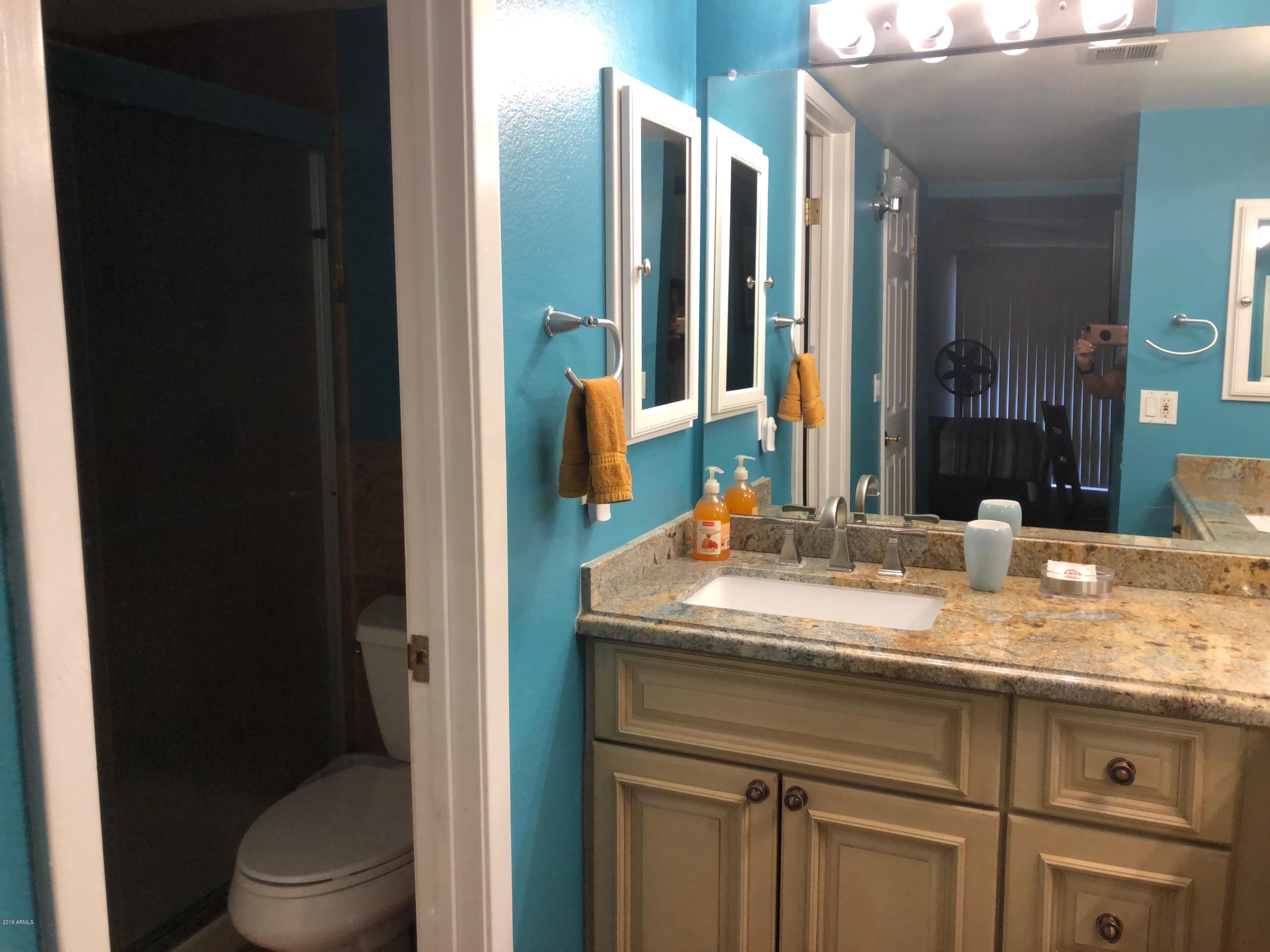 7910 East Thomas Road, Unit 226 Scottsdale, AZ 85251 - Photo 11 of 18 a bathroom with a granite countertop sink and a mirror