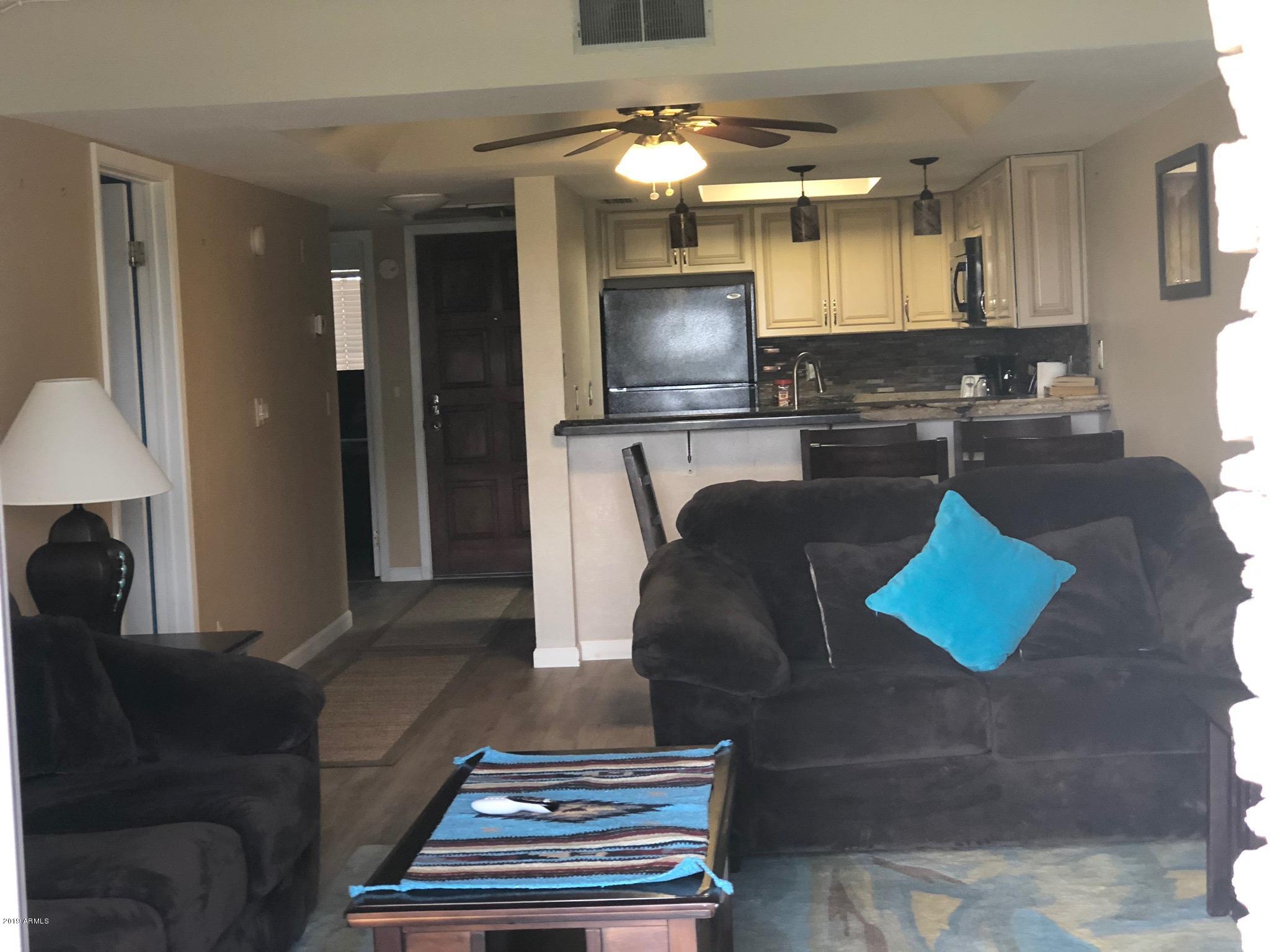 7910 East Thomas Road, Unit 226 Scottsdale, AZ 85251 - Photo 15 of 18 a living room with furniture and a flat screen tv