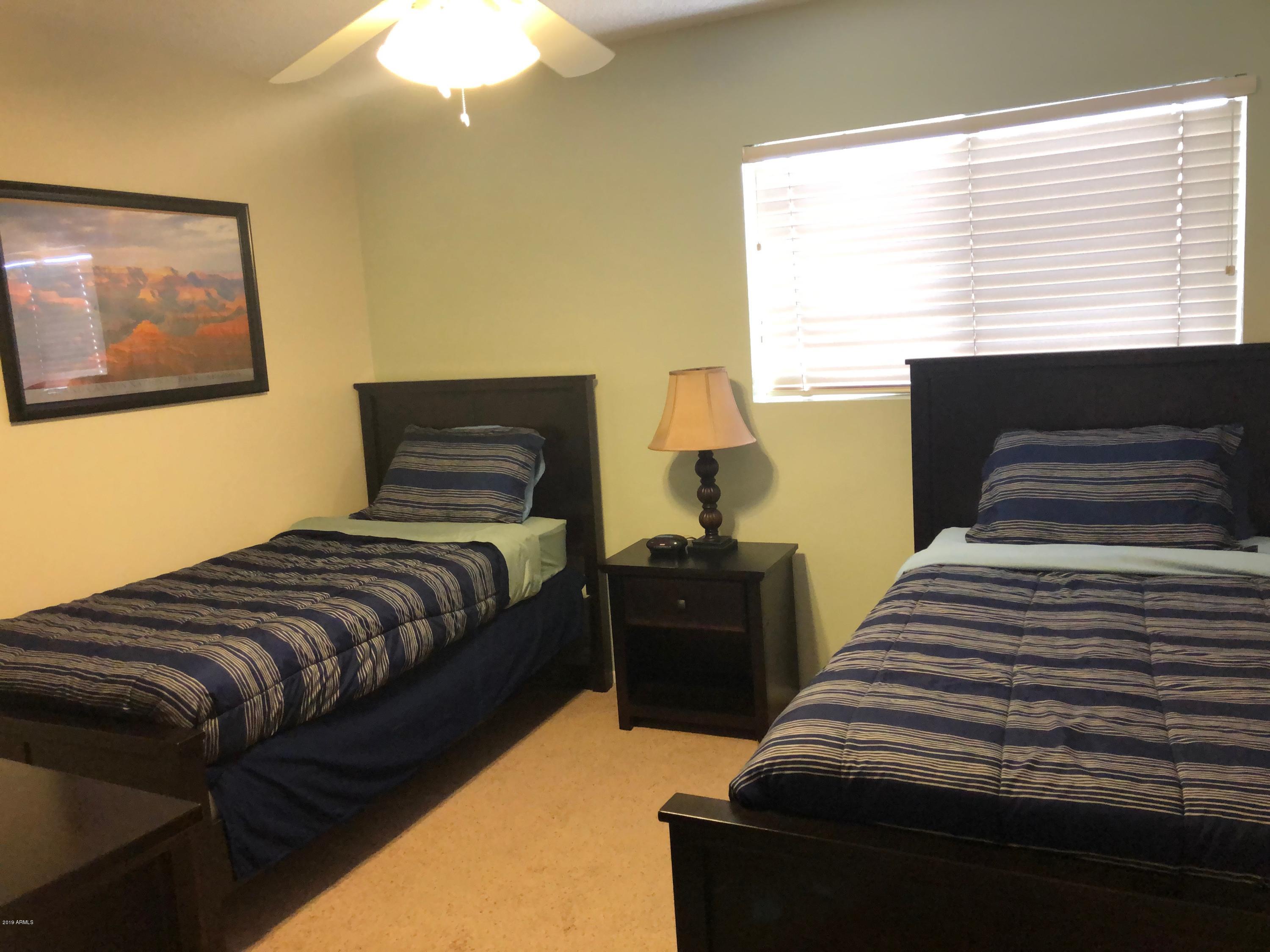 7910 East Thomas Road, Unit 226 Scottsdale, AZ 85251 - Photo 7 of 18 a bedroom with a bed and wooden floor