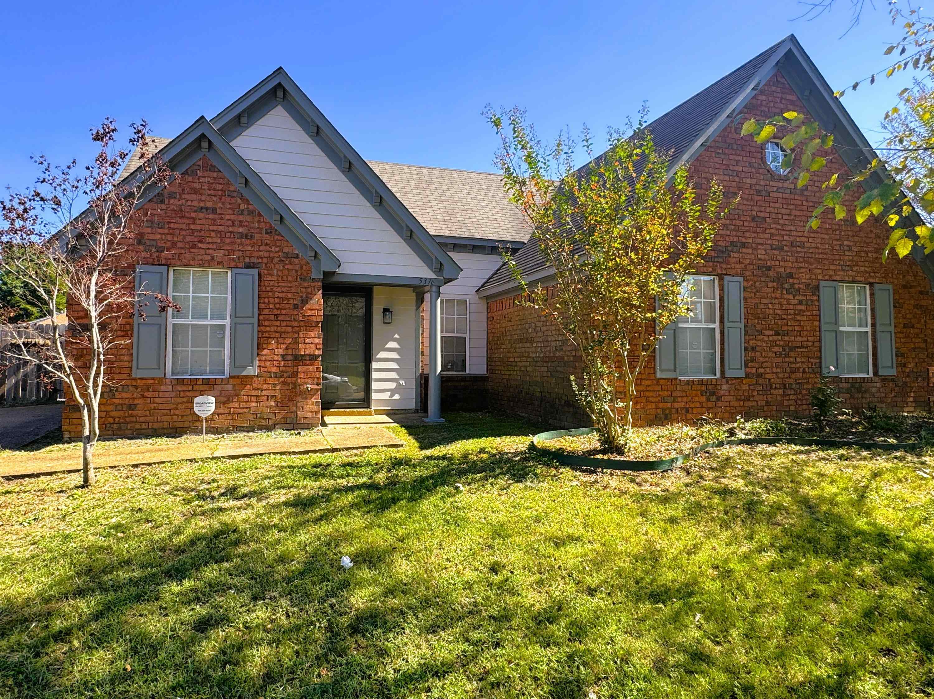 a front view of a house with a yard