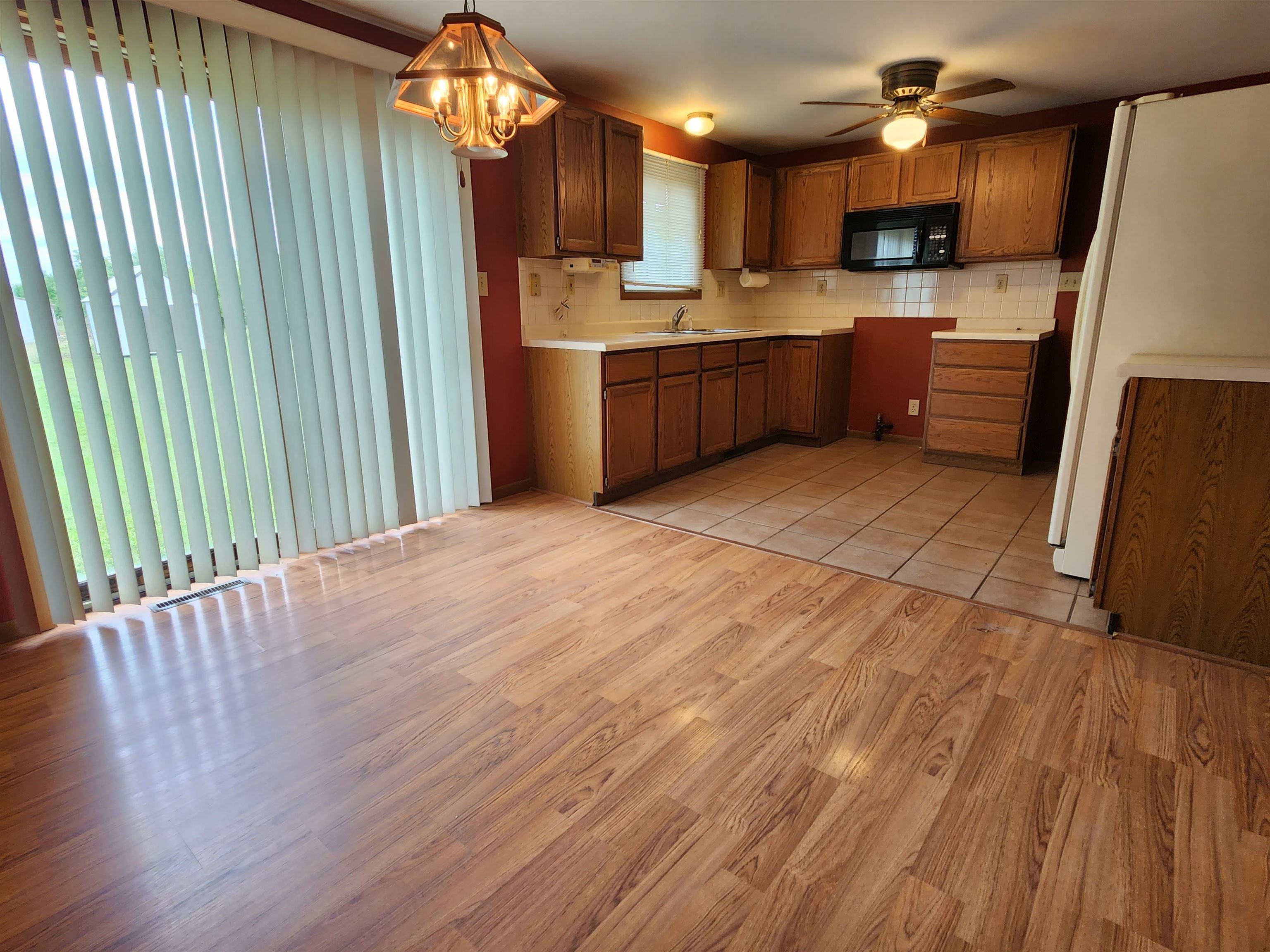 3443 Eddie Road Winnebago, IL 61088 - Photo 11 of 29 a large kitchen with cabinets and wooden floor