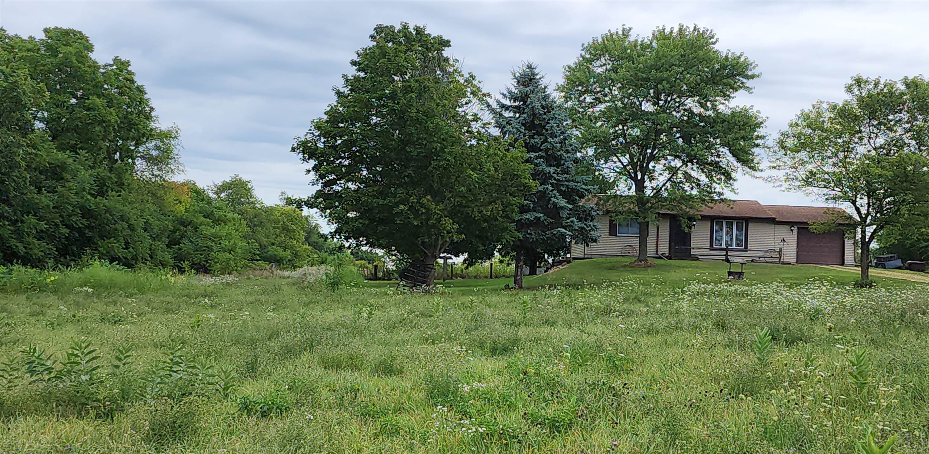 3443 Eddie Road Winnebago, IL 61088 - Photo 10 of 29 a view of a house with a garden