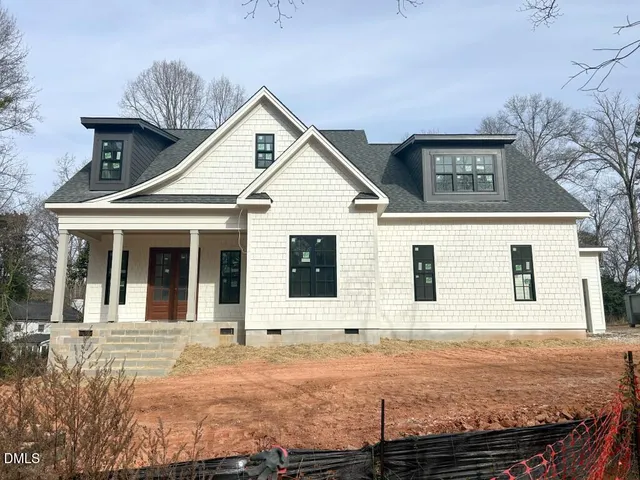 a view of a white house with large windows