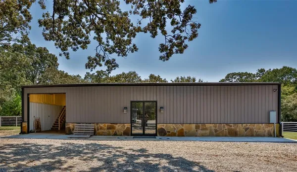 a view of a house with a backyard and a tree