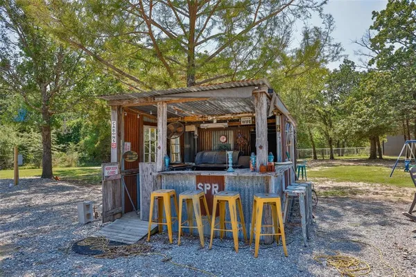 a view of a living room with a floor to ceiling window and wooden floor