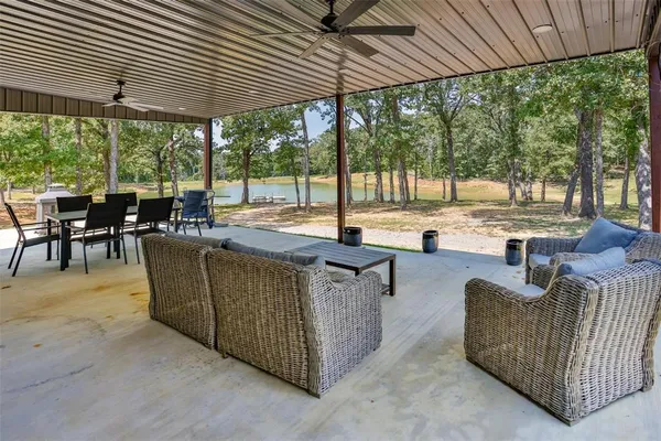 an outdoor living space with patio furniture and garden view