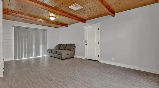 a living room with hard wood floors and a wooden floors