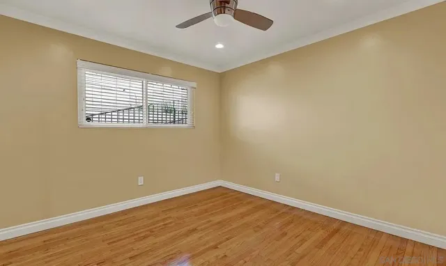 wooden floor in an empty room with a window