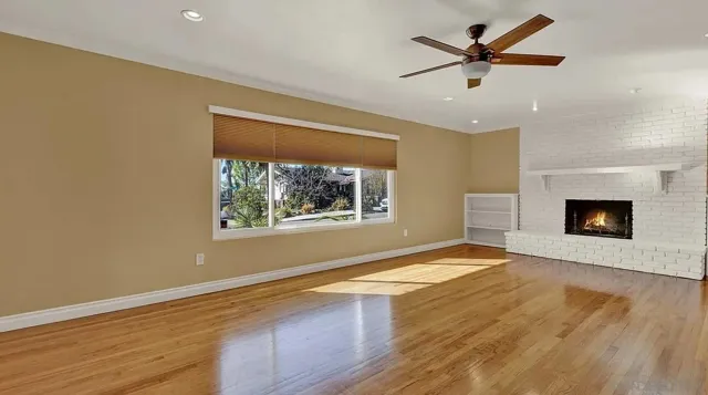 wooden floor in an empty room with a window