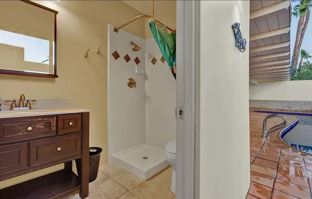 a bathroom with a shower and a sink