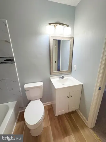 a bathroom with a sink toilet and mirror