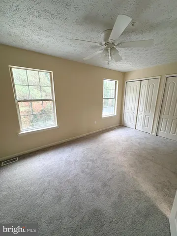 an empty room with a empty space and windows