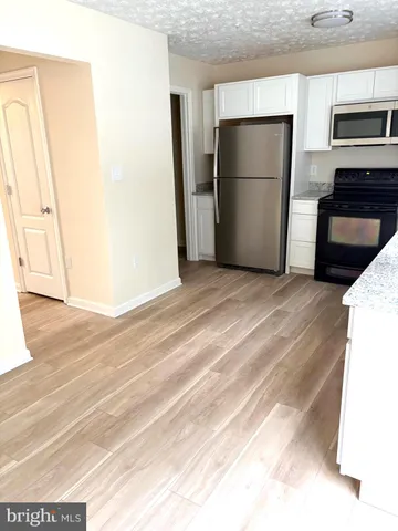 a view of a kitchen with a refrigerator