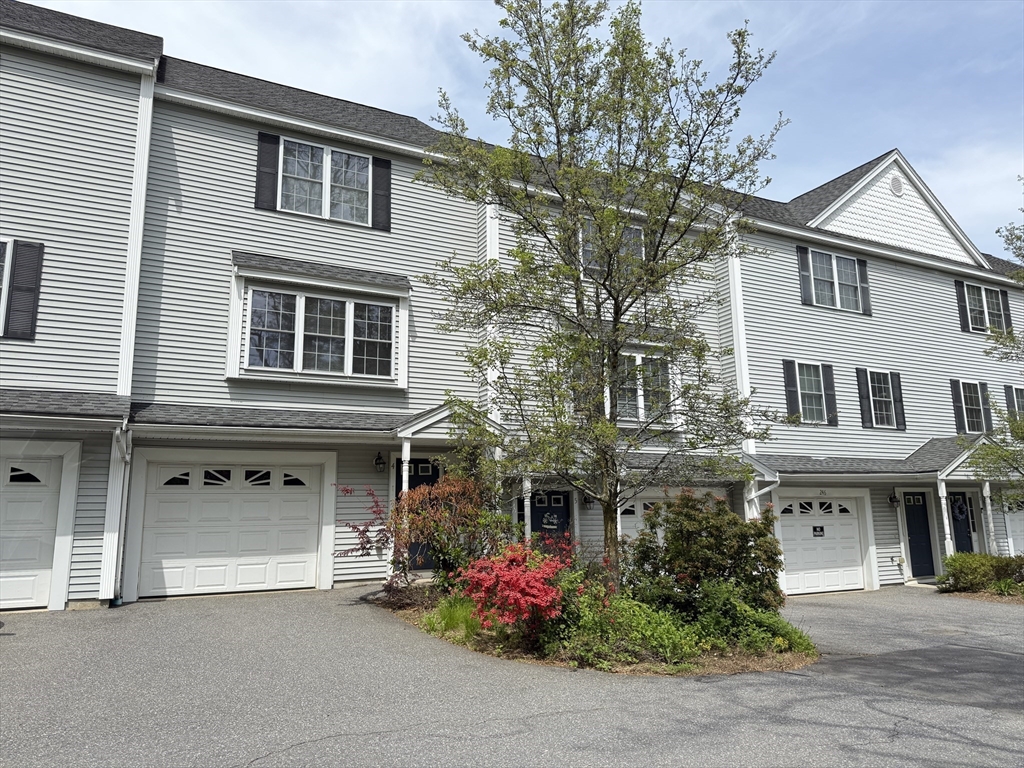 246 Main Street, Unit 4 Acton, MA 01720 - Photo 1 of 1 a front view of a house with plants