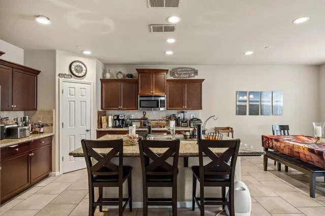 a view of a dining room with furniture and a chandelier