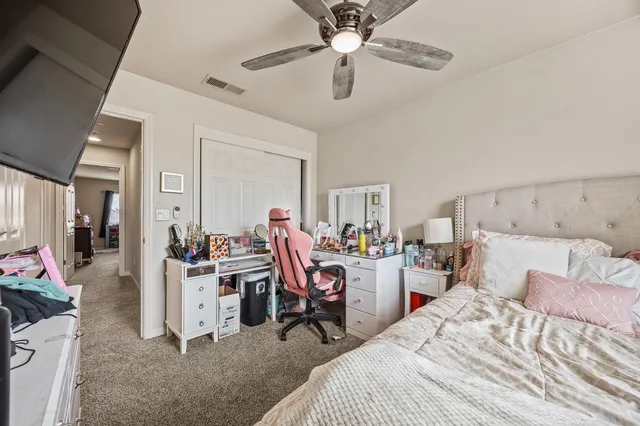 a bed room with a bed and a chair