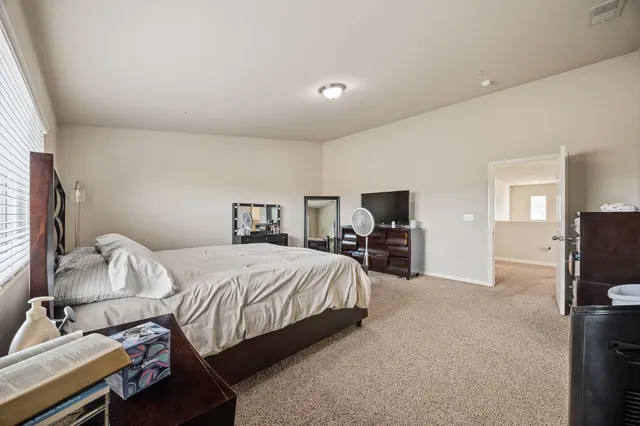 a bedroom with a bed and a tv