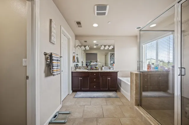 a large bathroom with a glass door shower and sink