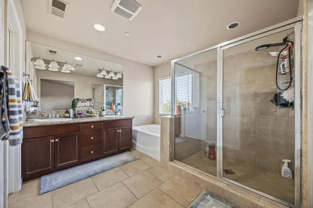 a spacious bathroom with a shower sink vanity and mirror