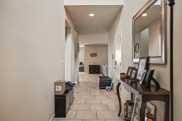 a view of hall way with furniture and large windows