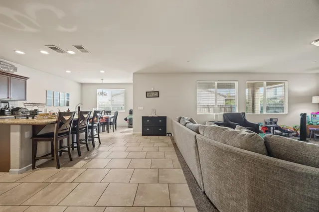 a living room with furniture a dining table and view kitchen view