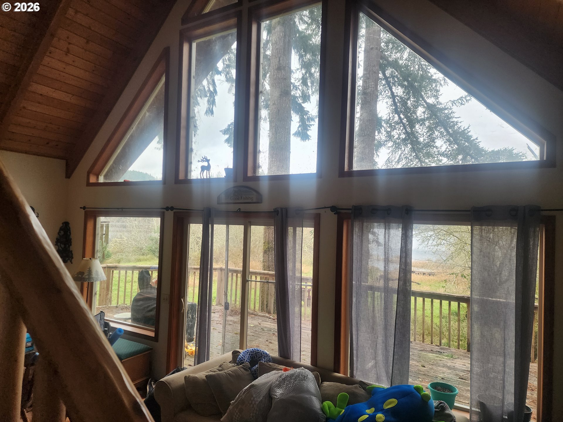 3117 South Tenmile Lakeside, OR 97449 - Photo 12 of 33 a living room with furniture and windows