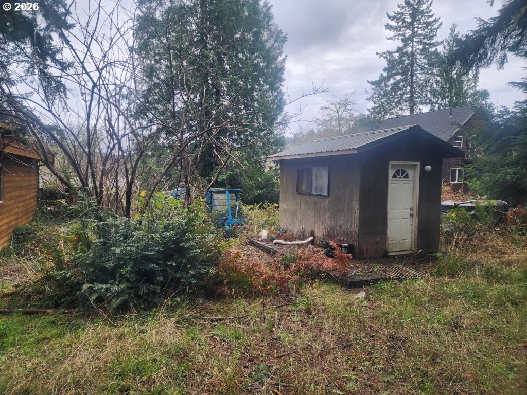 3117 South Tenmile Lakeside, OR 97449 - Photo 20 of 33 a view of a barn house in the middle of forest