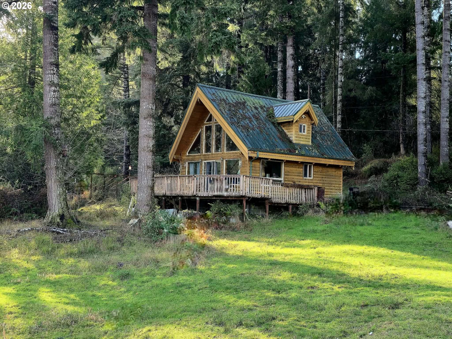 3117 South Tenmile Lakeside, OR 97449 - Photo 31 of 33 a wooden house with swimming pool in front of it