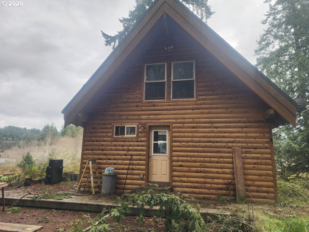 3117 South Tenmile Lakeside, OR 97449 - Photo 4 of 33 a brick house with a large windows