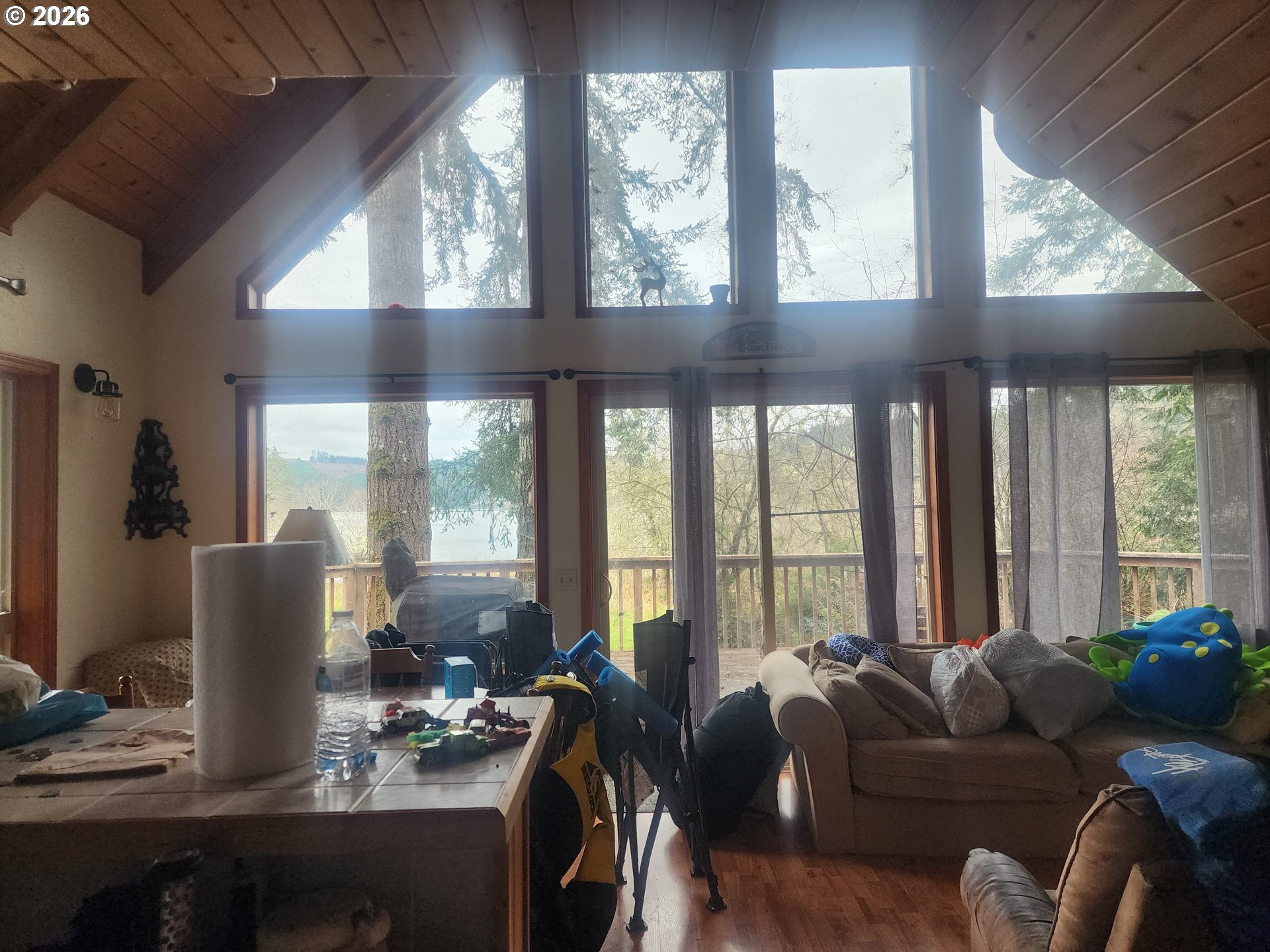 3117 South Tenmile Lakeside, OR 97449 - Photo 7 of 33 a living room with furniture and large windows