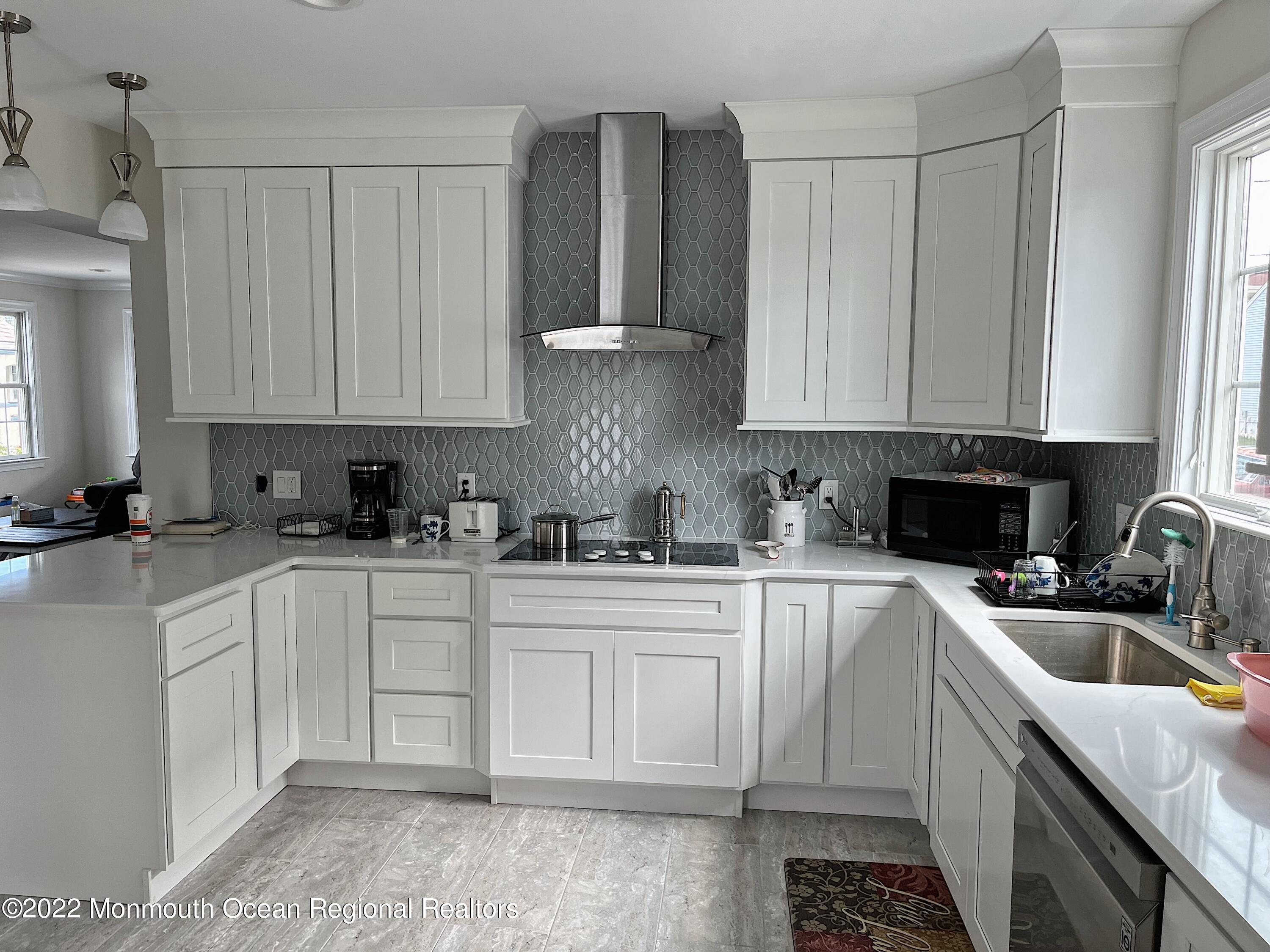 a kitchen with stainless steel appliances granite countertop a sink a stove and a refrigerator