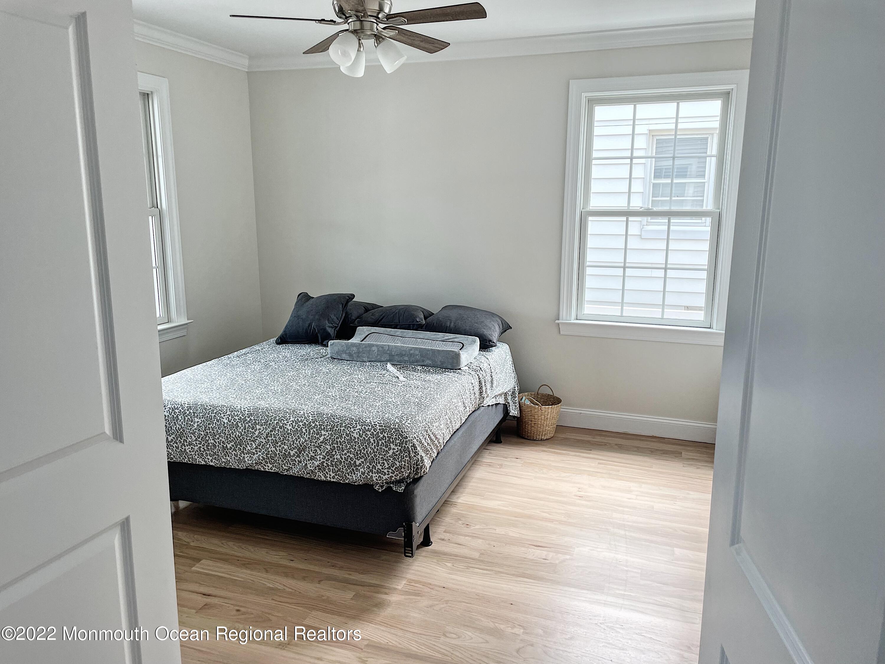 101 15th Avenue Belmar, NJ 07719 - Photo 2 of 10 a bedroom with a bed and a window