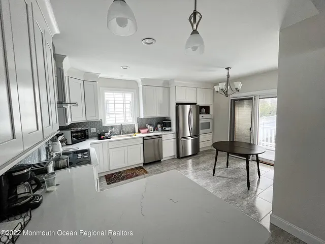 a kitchen with refrigerator and cabinets
