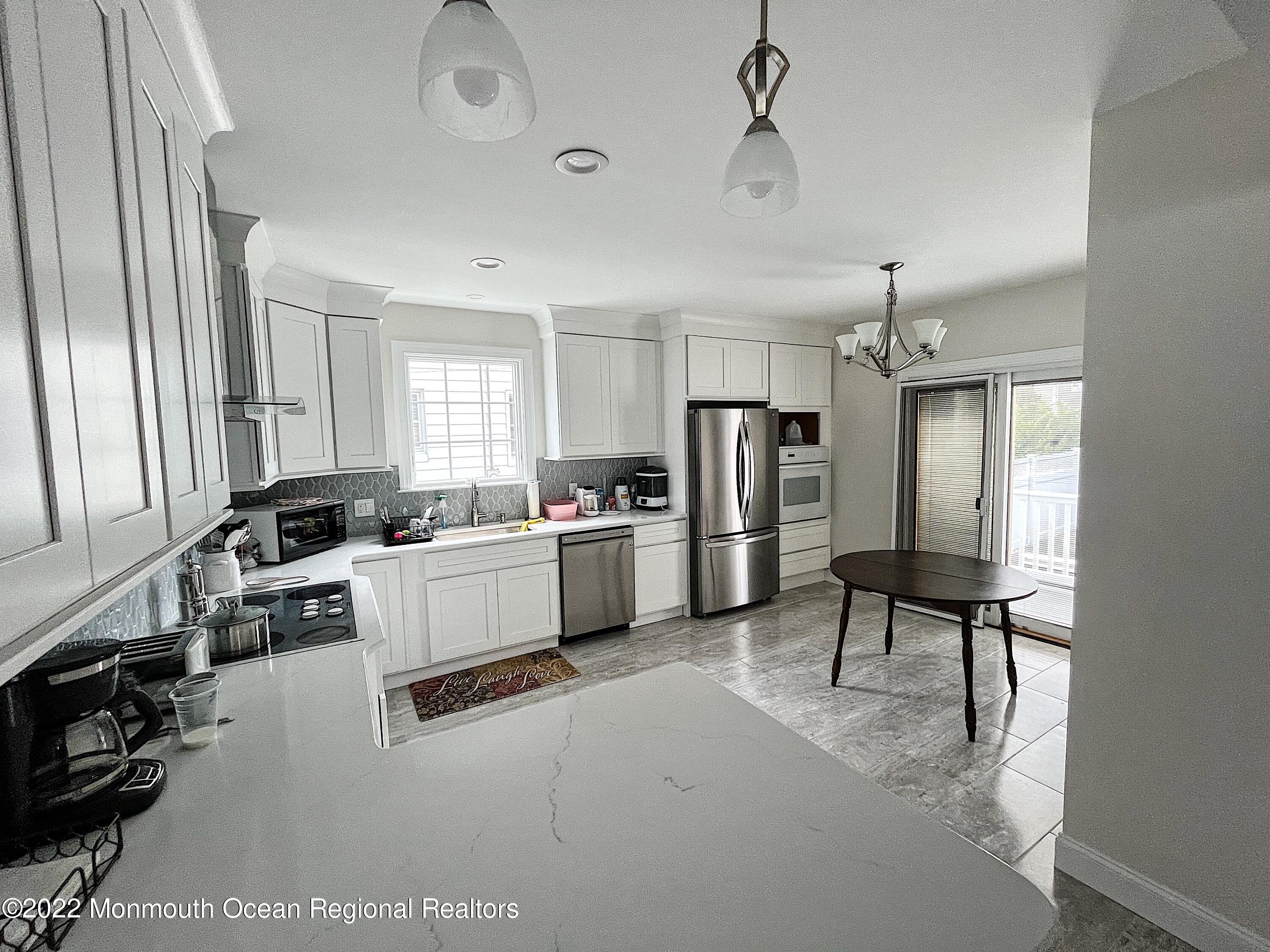 101 15th Avenue Belmar, NJ 07719 - Photo 7 of 10 a kitchen with refrigerator and cabinets