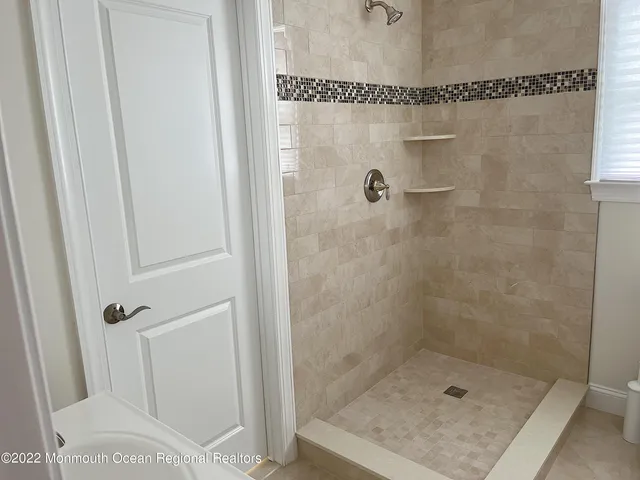 a bathroom with a glass shower door