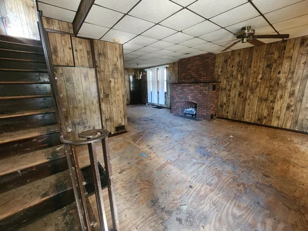 a view of an empty room with wooden walls