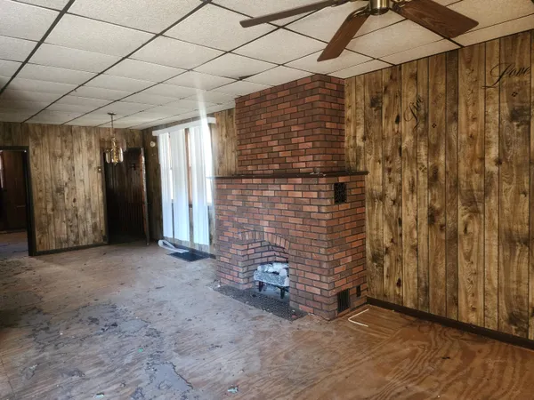 a view of a small space with wooden floor and a window