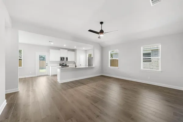 a view of kitchen with sink and wooden floor