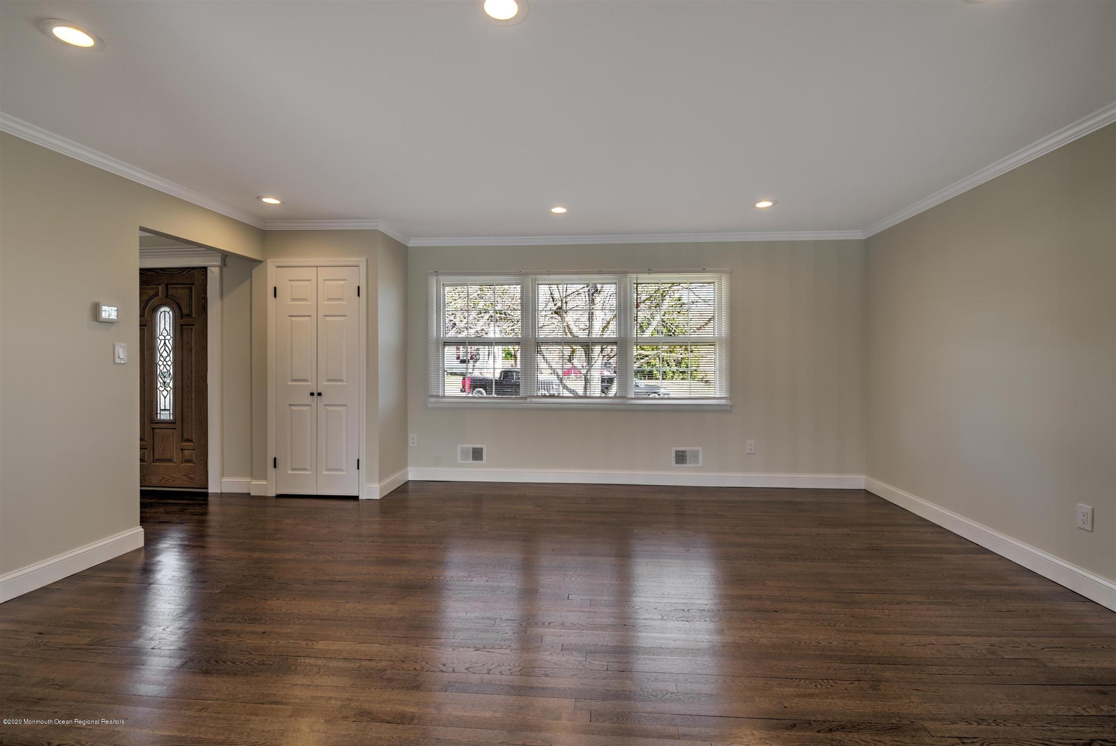 518 East Freehold Road Freehold, NJ 07728 - Photo 11 of 35 an empty room with wooden floor and windows