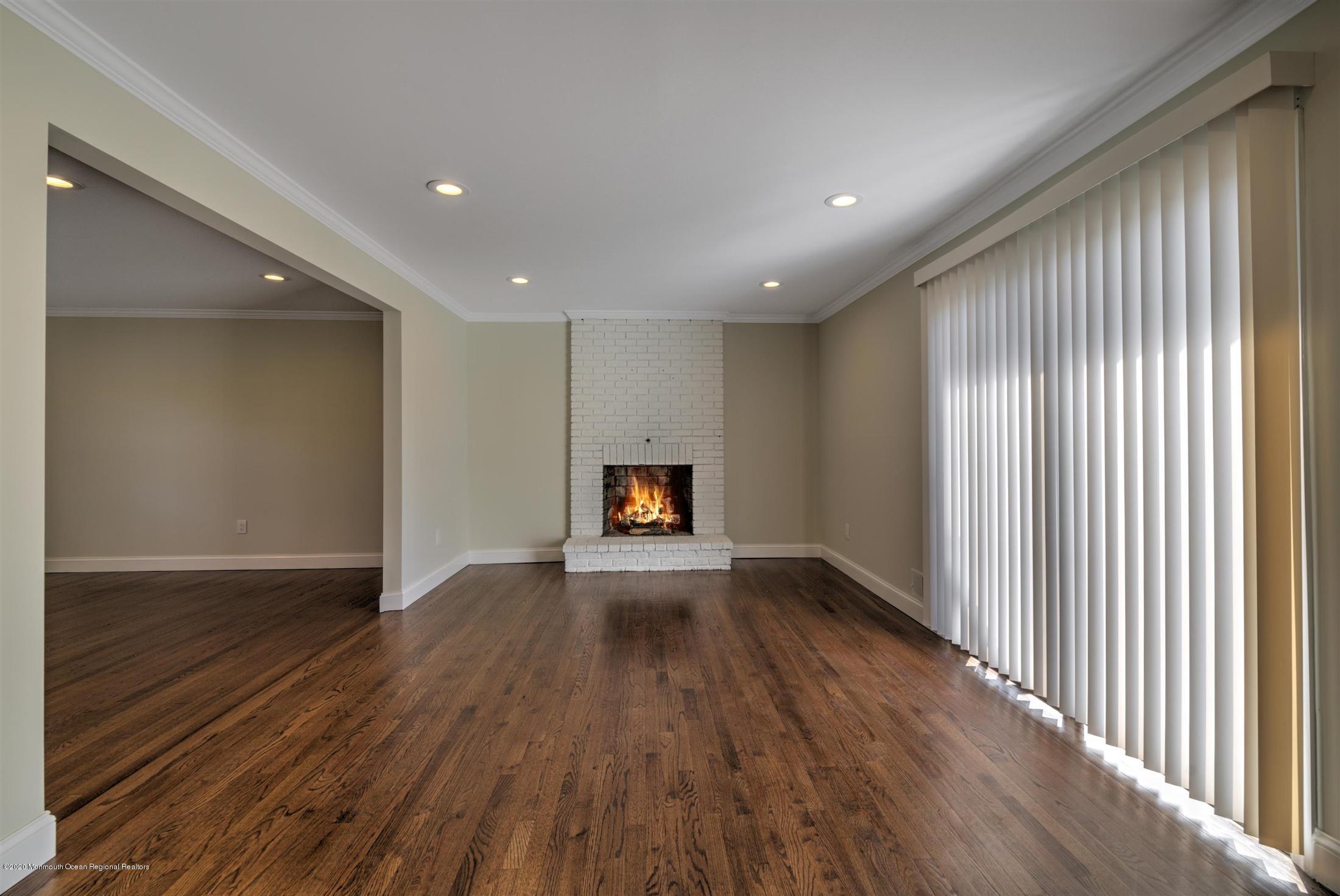 518 East Freehold Road Freehold, NJ 07728 - Photo 13 of 35 a view of an empty room with wooden floor and a window